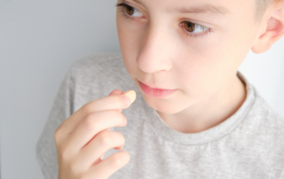 A close-up photograph of a young child, referencing new autism treatments like leucovorin following updates from Washington, D.C.